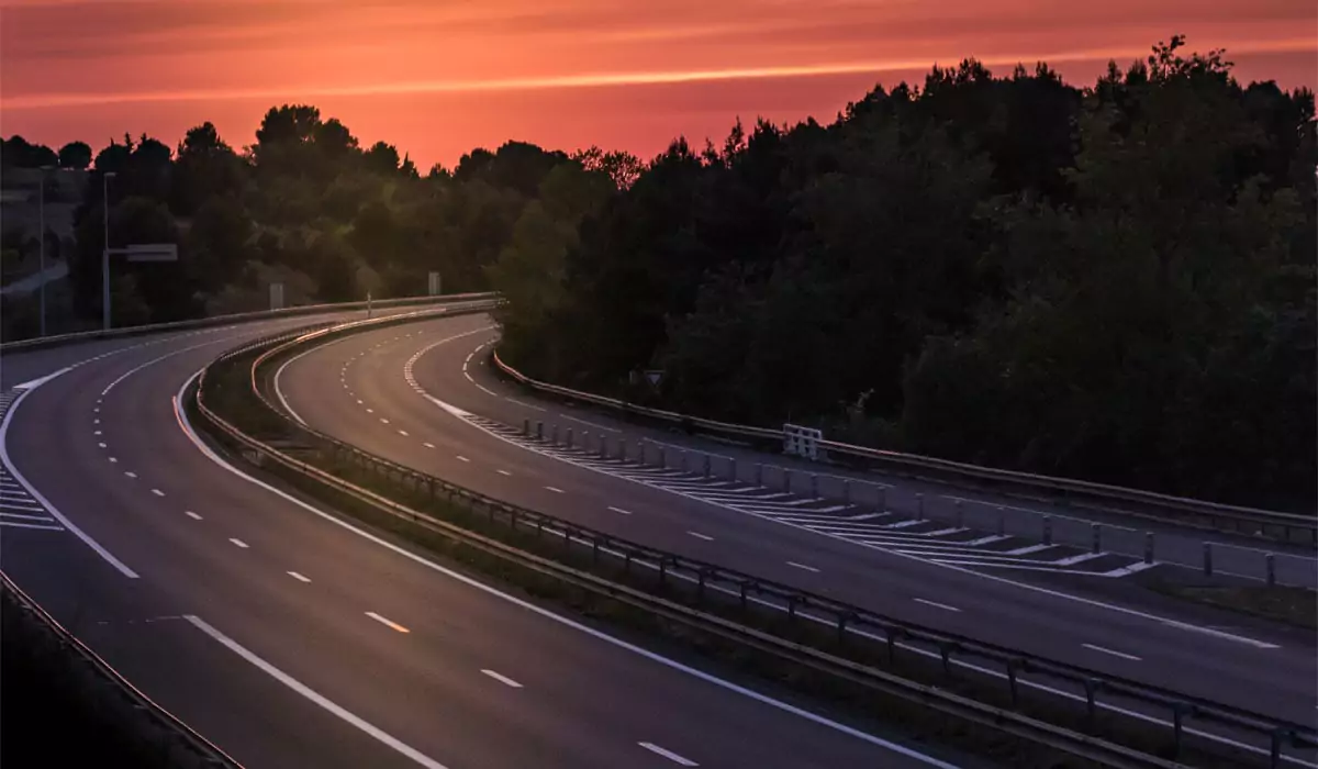 Wilson Small Business Accounting an image of a interstate curve in the forest at sunset